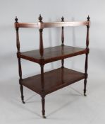 An early Victorian mahogany three tier whatnot, with baluster turned uprights and castor feet, W.2ft