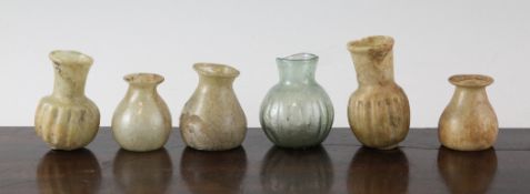 Six Roman glass flasks, 2nd / 3rd century A.D., of varying form, some with iridescence, 1.5in. to