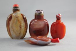 Four Chinese chalcedony snuff bottles, one of pebble form with varying inclusions in the stone,