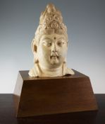 A Chinese carved stone head of a Bodhisattva, in Yuan Dynasty style, 13.25in.; later wood plinth