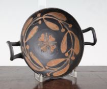 A Greek pottery kylix, Southern Italy, c.4th century B.C., black-glazed and red painted to the