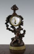 An early 20th century French bronzed and green onyx mantel timepiece, with putto and flower case