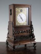 A 19th century Chinese huali wood mantel clock, with enamelled Roman dial and visible escapement and