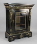 A 19th century French gilt mounted ebonised pier cabinet the single glazed door between figural