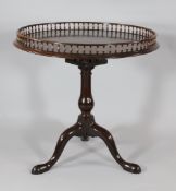 A George III mahogany circular tripod table, with galleried top, birdcage movement and tripod