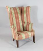 A George III mahogany wing back tub chair, on tapered square legs