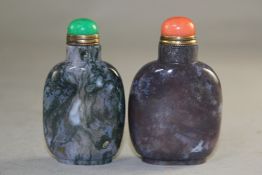 Two Chinese moss agate snuff bottles, one with green inclusions, the other with a lavender hue, both
