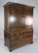 A late 18th century oak linen press, with two cupboard doors over six drawers, on bracket feet, W.