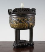 A Chinese parcel gilt bronze censer, Ding, with wood cover and stand, 18th / 19th century, cast in