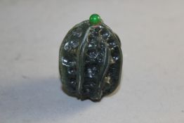 A Chinese spinach green jade snuff bottle, carved as a walnut, 4cm., stopper