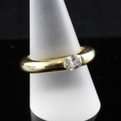 A Cartier 18ct gold and gypsy set solitaire diamond ring, the oval cut stone approximately 0.60ct,