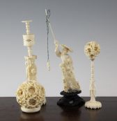 Two Chinese ivory concentric puzzle balls on stands and a figure of a fisherman, early 20th century,