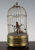 A Continental embossed brass singing `birds in a cage` musical box, 10.5in.