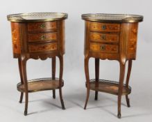 A pair of late 19th century French oval mahogany inlaid side tables, with pierced brass gallery