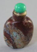 A Chinese jasper snuff bottle, the brown stone with green russet and grey inclusions, 6.7cm.,