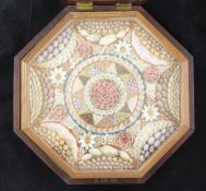 An early 19th century sailor`s shellwork panel, of octagonal form, contained within a mahogany outer