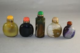 Five Chinese stained agate snuff bottles, of various colour, one green stained banded agate of