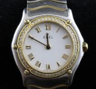 A lady`s stainless steel Ebel quartz wrist watch, with diamond set 18ct gold bezel, with white Roman