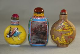 Two Chinese enamelled glass snuff bottles, the first inside painted with landscapes, the second