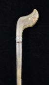 An early 20th century sectional rhino horn walking cane, with bone inlaid decoration, 3ft 2in.; With