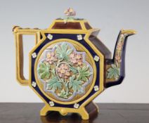 A Brown, Westhead and Moore majolica teapot, c.1870, the octagonal body moulded in relief with