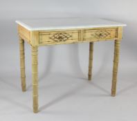 An Edwardian bamboo effect pine marble top side table, with two drawers and bamboo style legs, W.3ft