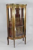 A French gilt mounted serpentine mahogany vitrine, with marble top, W.2ft 3in. H.4ft 7in.