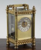 An Edwardian gilt brass hour repeating carriage clock, with silvered arabic dial and movement