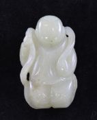 A Chinese celadon jade carving of a boy, holding a flowing ribbon, or tendril, around his head,