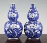 A pair of Chinese blue and white double gourd shaped vases, late 19th / early 20th century, each
