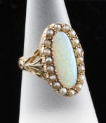 A late Victorian 15ct gold white opal and split pearl oval dress ring, with pierced shoulders,