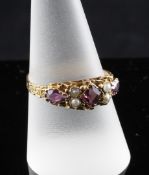 A 1920`s 15ct gold almandine garnet and split pearl dress ring, with pierced setting and engraved