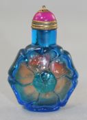 A Chinese overlaid glass `flower` snuff bottle, in blue glass over amber tinted glass with gilt