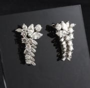 A pair of diamond set 18ct white gold earrings, of stylised foliate design, set with baguette,