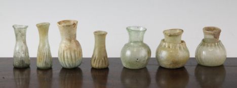 Seven Roman glass vessels, 2nd-4th century A.D, some with mineral iridescence, largest 3in.