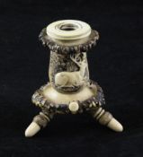 A late 19th century Black Forest stag horn and bone inkwell, carved with a seated stag, 3in.