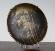 A Japanese Komai style inlaid iron dish, Meiji period, decorated with buildings by a riverscape,