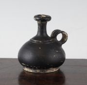 A Greek black glazed pottery pear shaped oil vessel, Southern Italy, c.4th century B.C., with