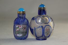 Two Chinese overlaid and inside painted glass snuff bottles, the first decorated with birds amid