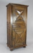 A 17th century North Italian walnut cabinet, with two geometric panel doors and central drawer, W.