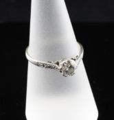 A 1920`s 18ct gold and platinum solitaire diamond ring, with diamond set shoulders, the central