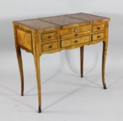 A French marquetry inlaid poudreuse, over an arrangements of drawers, on scroll legs, W.2ft 8in.