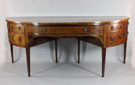 A large George III mahogany and crossbanded demi-lune sideboard, with an arrangement of drawers