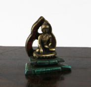 A Tibetan bronze and stone mounted figure of Buddha, seated on a lotus throne and a malachite