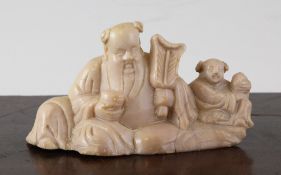 A rare Chinese pink tinted soapstone group, 17th / 18th century, depicting the seated figure Zhongli
