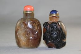 Two cameo agate snuff bottles, the first carved from a black inclusion in the stone as a figure