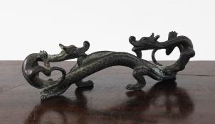 A Chinese bronze `dragon` brush rest, modelled as two scrolling confronting dragons, 6.5in.