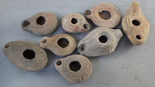 Eight Roman pottery oil lamps, 2nd-4th century A.D., of varying forms and sizes, largest 3.5in.