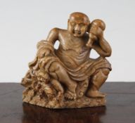 A Chinese soapstone group of a Luohan and a demon, 17th/18th century, the main figure seated and