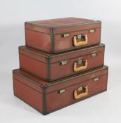 A 1960`s graduated set of three Louis Vuitton suitcases, with brass fittings and leather handles,